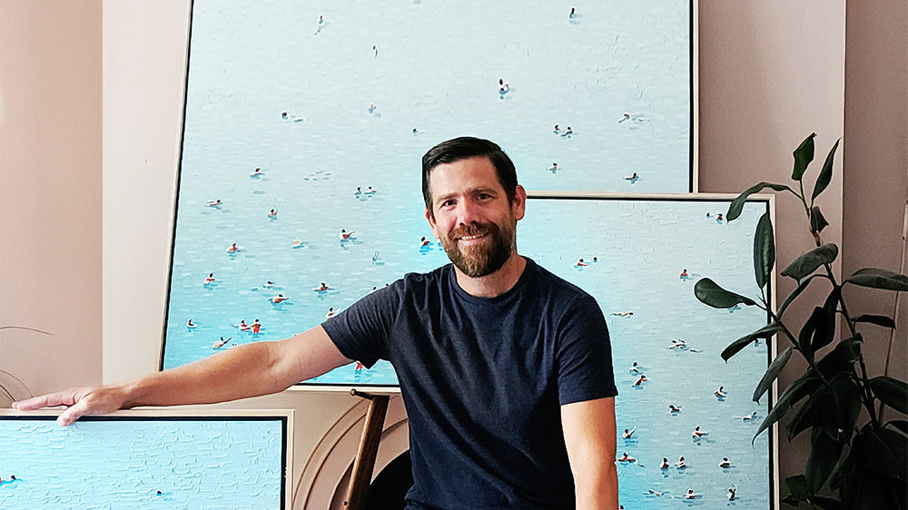 Steven Dragan in his studio with Swimming in Color paintings