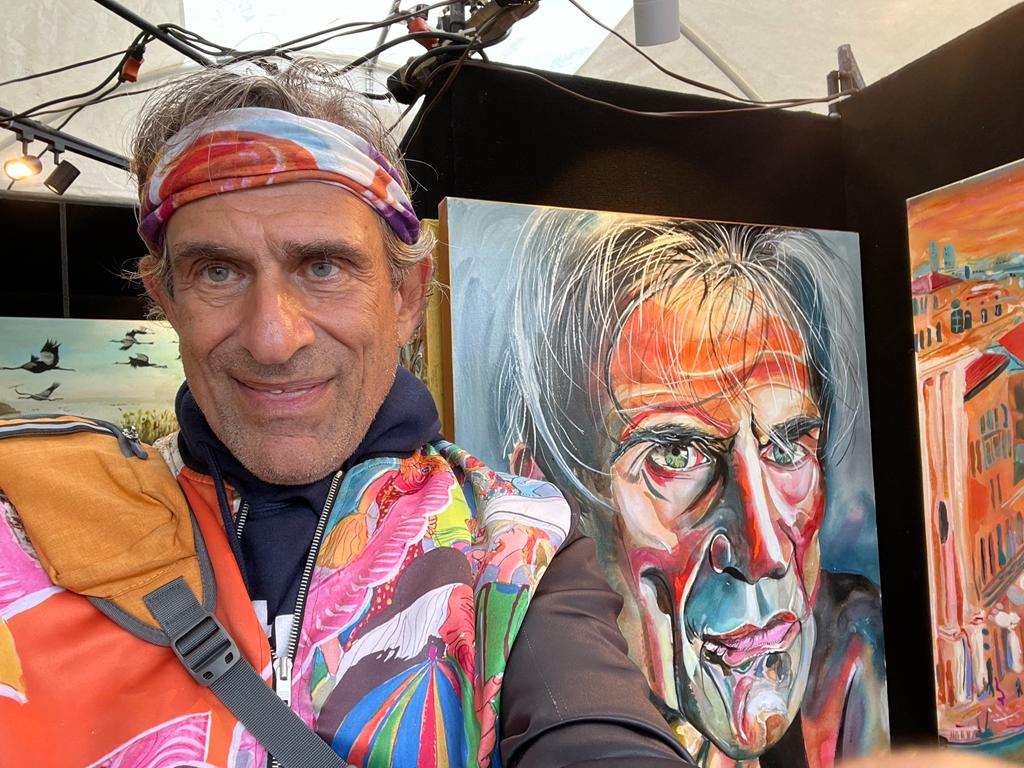 Artist Yoram Gal with his self-portrait